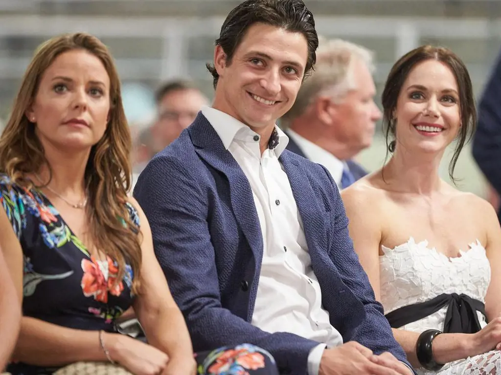 Scott Moir with his ice dance partner Tessa Virtue on the right and his wife Jackie Mascarin on the left.