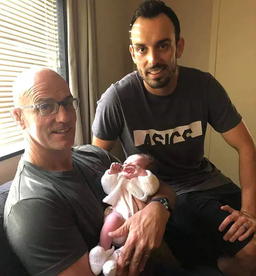 Daryl poses for a photo with his father John Mitchell carrying his granddaughter Addison on September 22, 2019