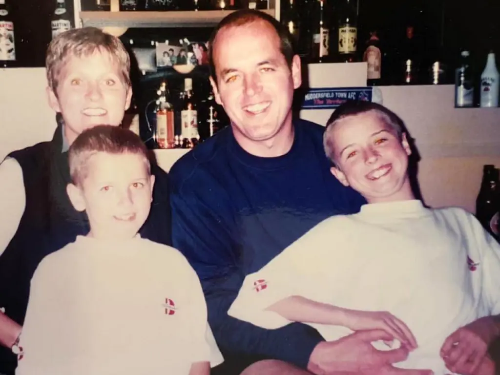 A childhood picture of Harry Kane with his parents and sibling.