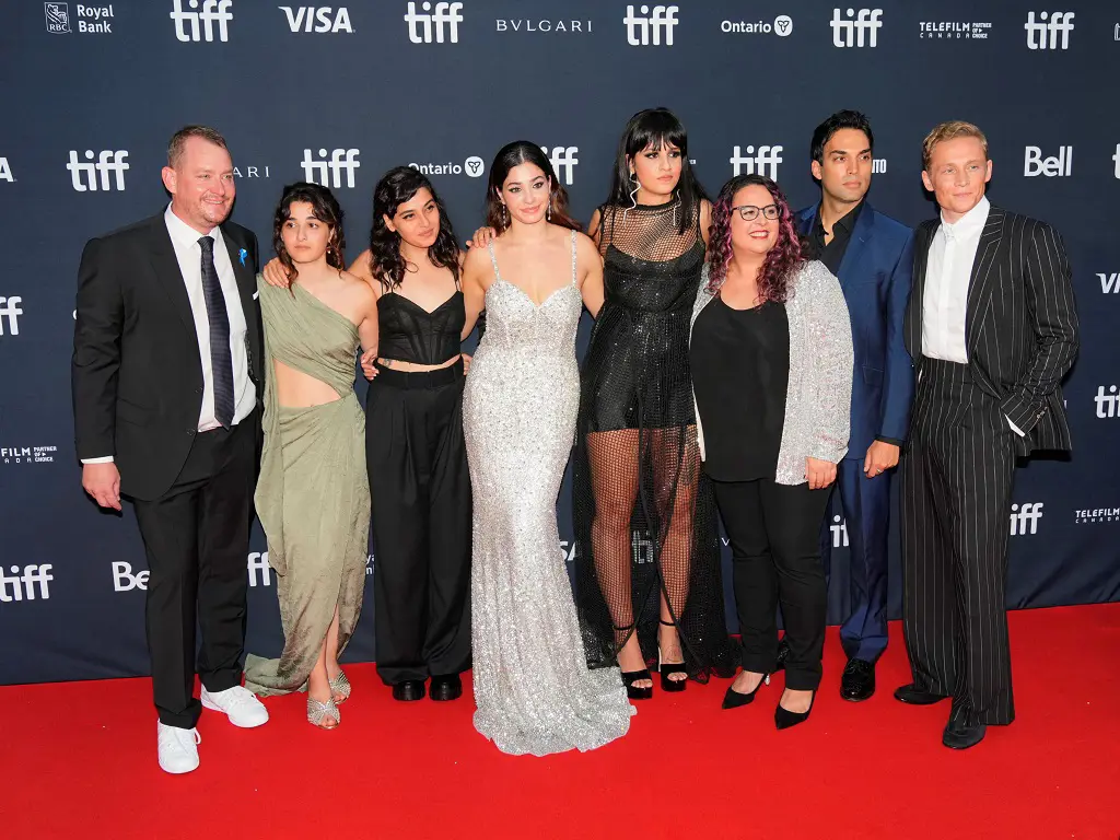  Sven Spannekrebs, Yusra Mardini, and Sara Mardini pictured with the casts of The Swimmers during the movie's world premiere at the TIFF in September 2022.