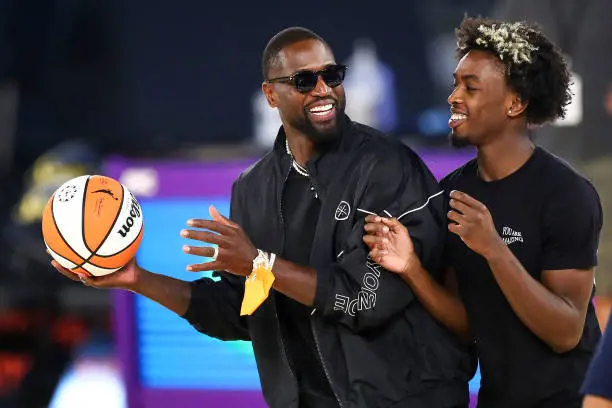 Former NBA player Dwyane Wade and his son Zaire Wade spend time on the court after the game between the Los Angeles Sparks and the Las Vegas Aces at Los Angeles Convention Center on June 30, 2021 in Los Angeles, California.