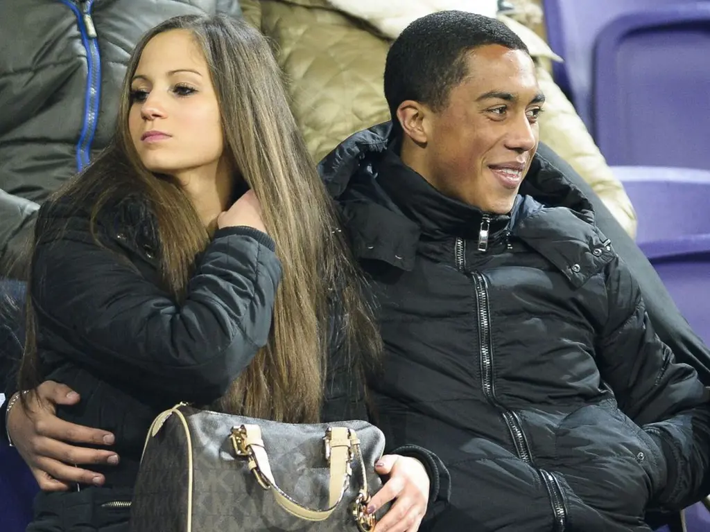 Youri Tielemans and his wife watching a match together.