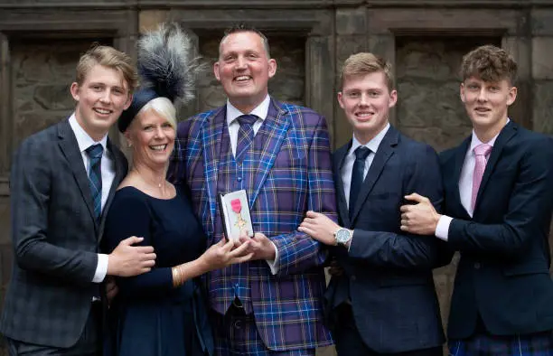 Former Scotland Rugby international and Motor Neurone campaigner Doddie Weir, with wife Kathy and their three sons receives OBE in 2019