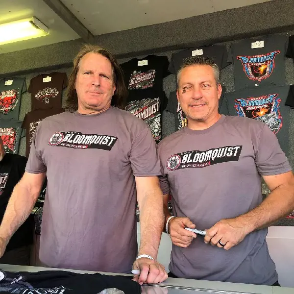 Scott and Chris shining their autograph in Bloomquist Racing's Merchandise  