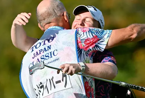 Gemma Dryburgh, right, of Scotland celebrates with her caddie Paul Heselden after winning the LPGA Tour's Toto Japan Classic at the Seta Golf Club in Shiga, Japan, Sunday, Nov. 6, 2022
