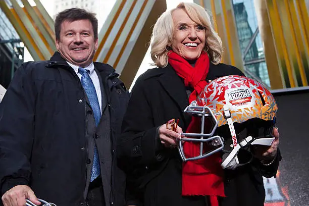 : Arizona Cardinals President Michael Bidwill (L) and Arizona Gov. Jan Brewer attend a ceremony for the NFL Super Bowl Host Committee to pass the hosting duties off to Arizona in 2014