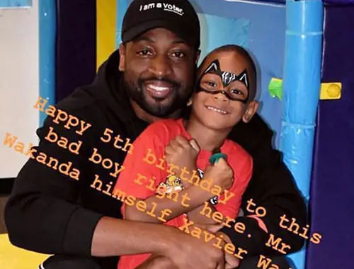 Xavier Wade and Dwyane Wade pose together during Xavier's fifth birthday party 
