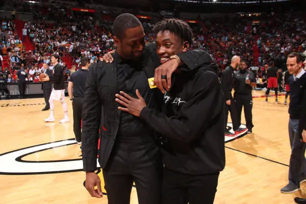 Dwayne Wade hugs his son Zaire Wade after his jersey retirement ceremony on February 22, 2020 at American Airlines Arena in Miami, Florida