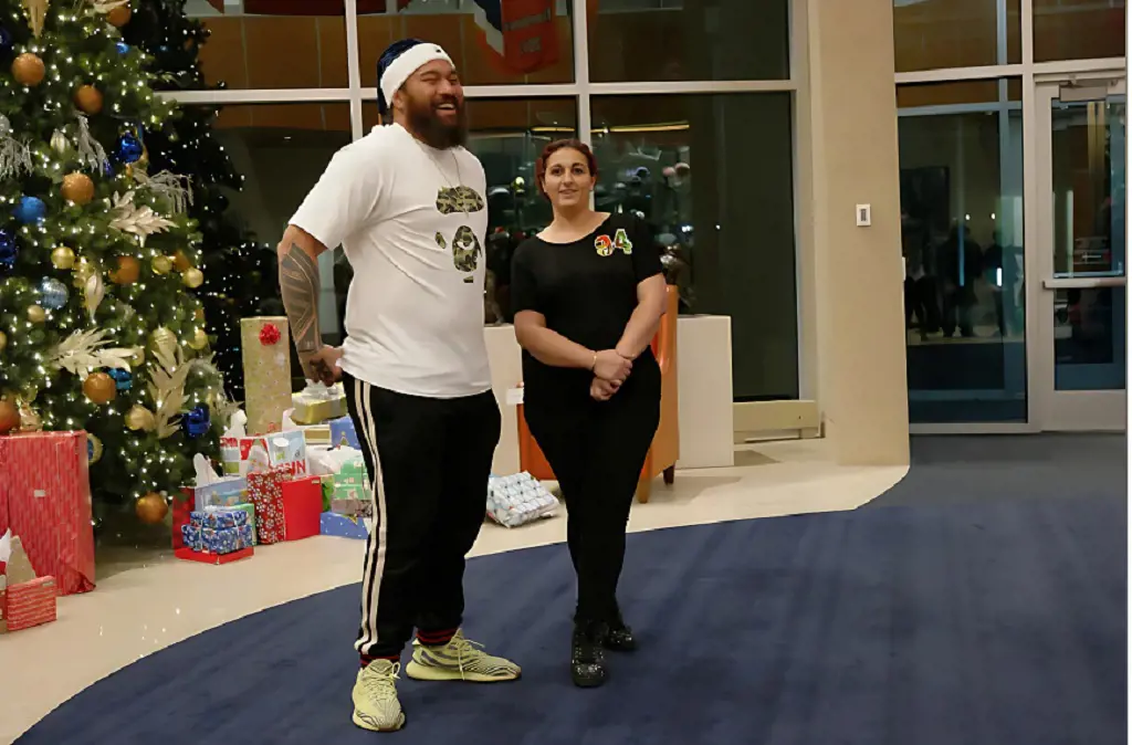 Domata Peko Sr. and his wife Anna  hosted  families the Pekos adopted for the holidays for a gift-giving experience at UCHealth  Training Center on December 21, 2018.