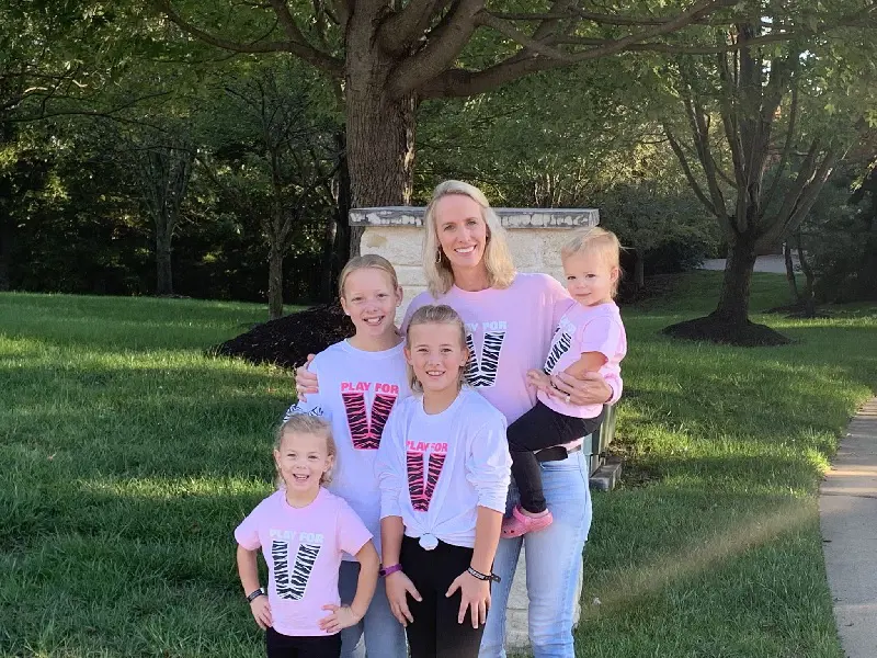 Lindsey with her 4 daughter wearing Play For V merch