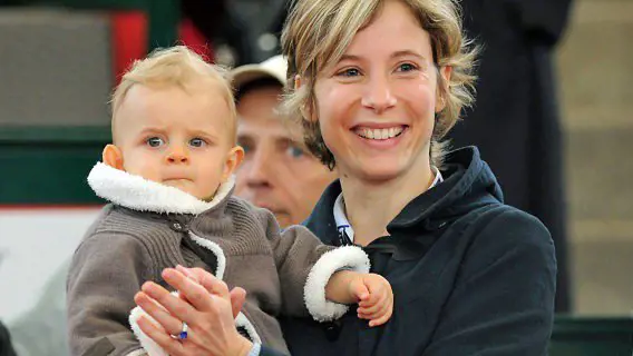 Carine Lauret with her son while attending a tennis match