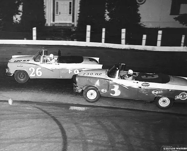 Curtis Turner (No. 26) and Normal Schihl (No. 3), both driving 1956 Ford Sunliner convertibles at Bowman Gray Stadium in Winston-Salem, North Carolina in 1956