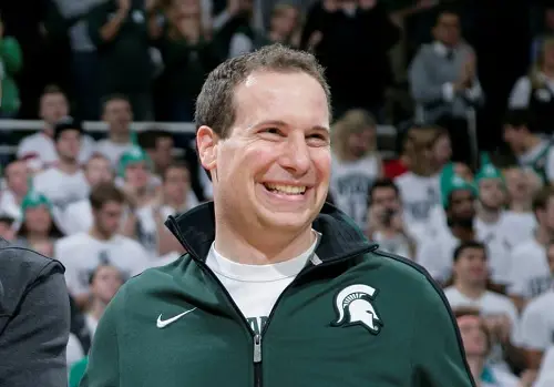 Mat Ishbia smiles for the camera as he attends Michigan State University's game and is all decked up in its jersey