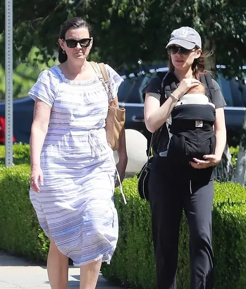 Kathleen Rooney pictured with her daughter Kate Mara as she cradles her baby while walking in a neighborhood in LA in 2019