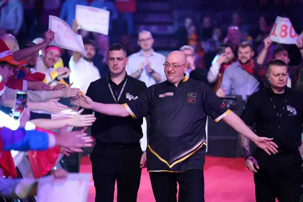 Andrew Gilding meets the fans as he walks out in World Darts Championship before facing Robert Owens on December 19,2022