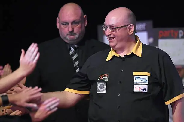 Andrew Gilding greets fans as he comes out to face against Darren Webster in 2014 