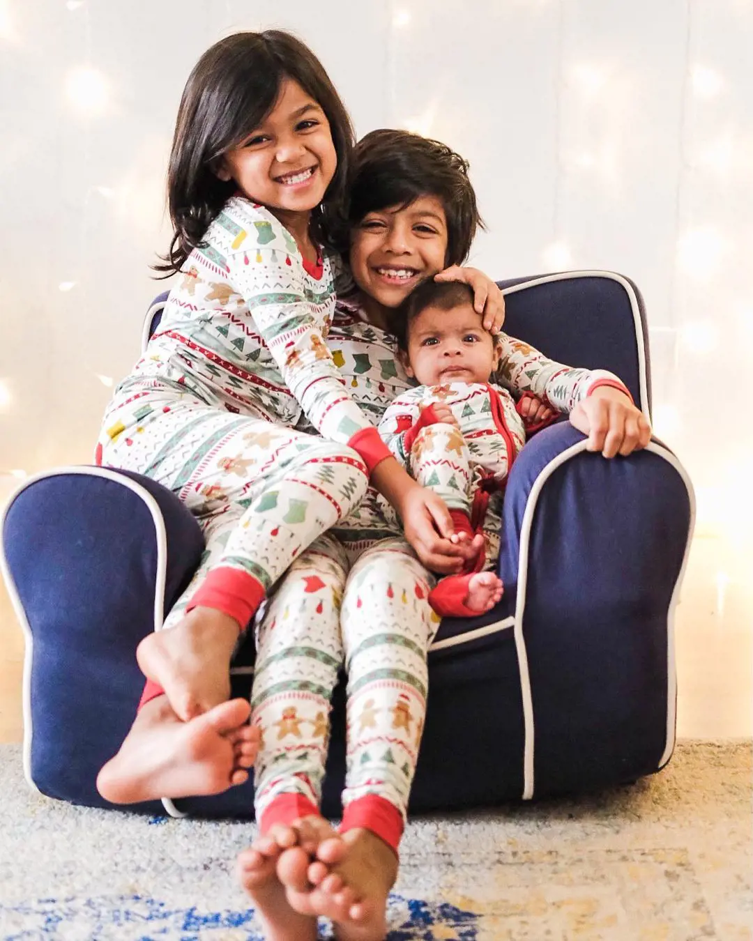 Arian and Shea show their love for their sister Zadie as they are photographed in their Christmas pyjamas