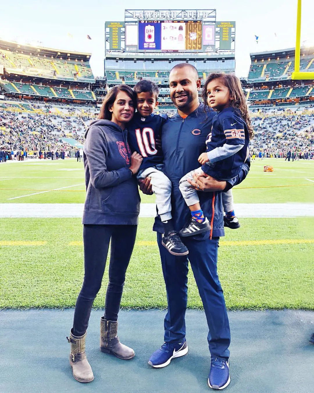 Sean and Ojus with their two kids at the Lambeau Field in 2018