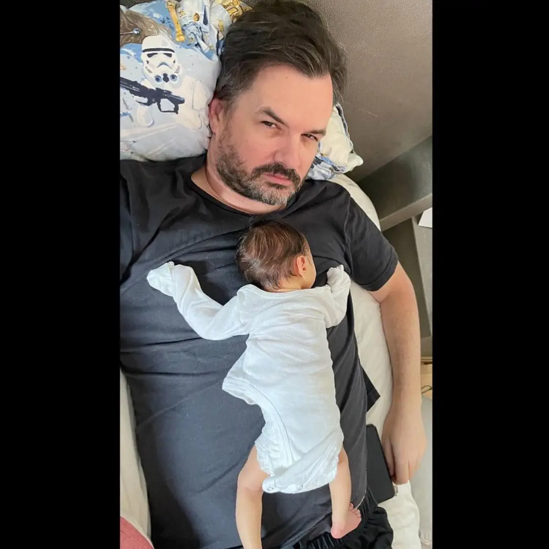 Jim with his child, Charlie Jefferies lying around in his house