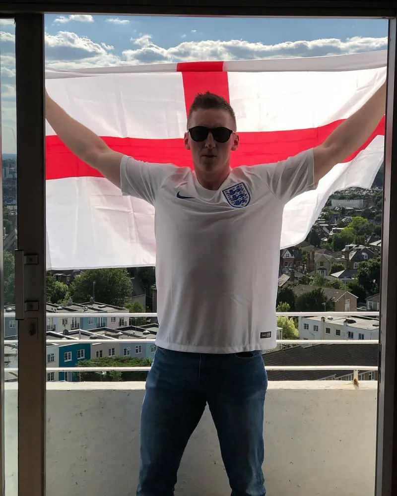 Ruaridh holding the flag of his national team, England in June 2018 before a game in Nizhniy Novgorod, Russia.
