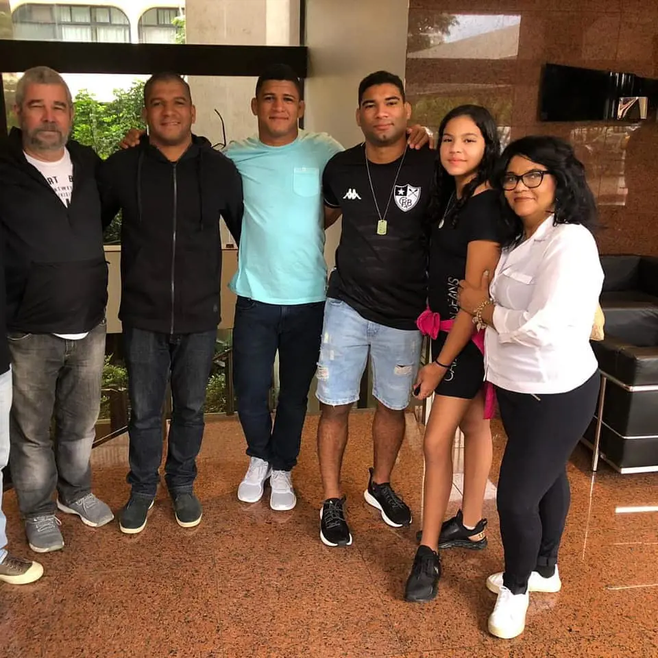 Gilbert Burns(centre) in blue shirt pictured with his family in September 2020 