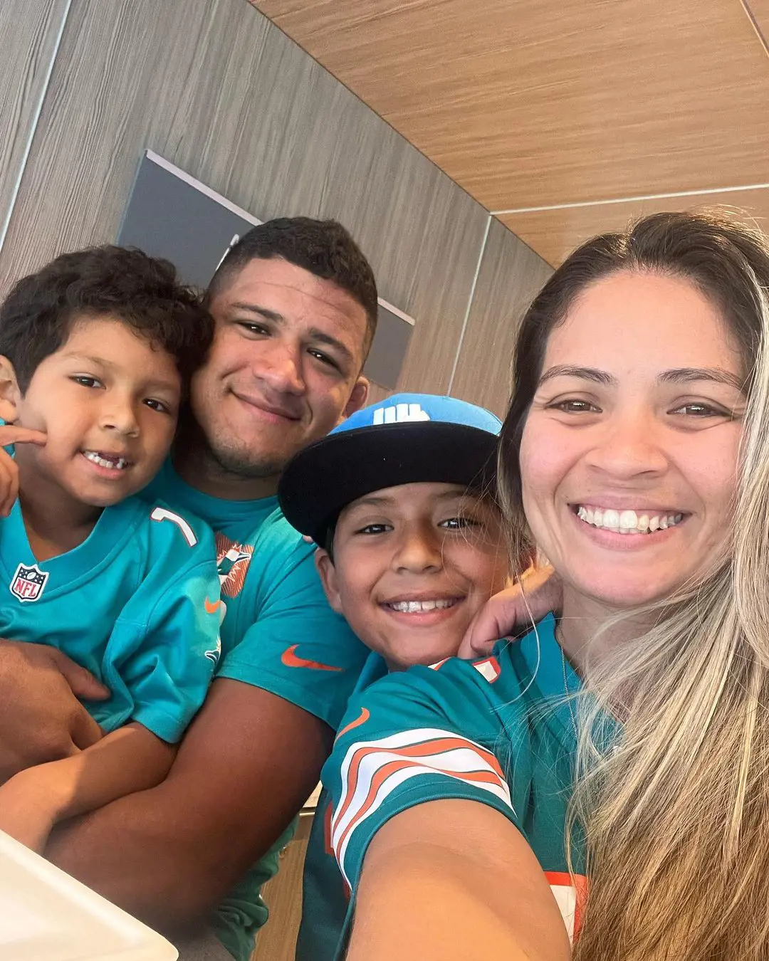 Burna with her boys shows her support for the Miami Dolphins as they visit the stadium in October 2022